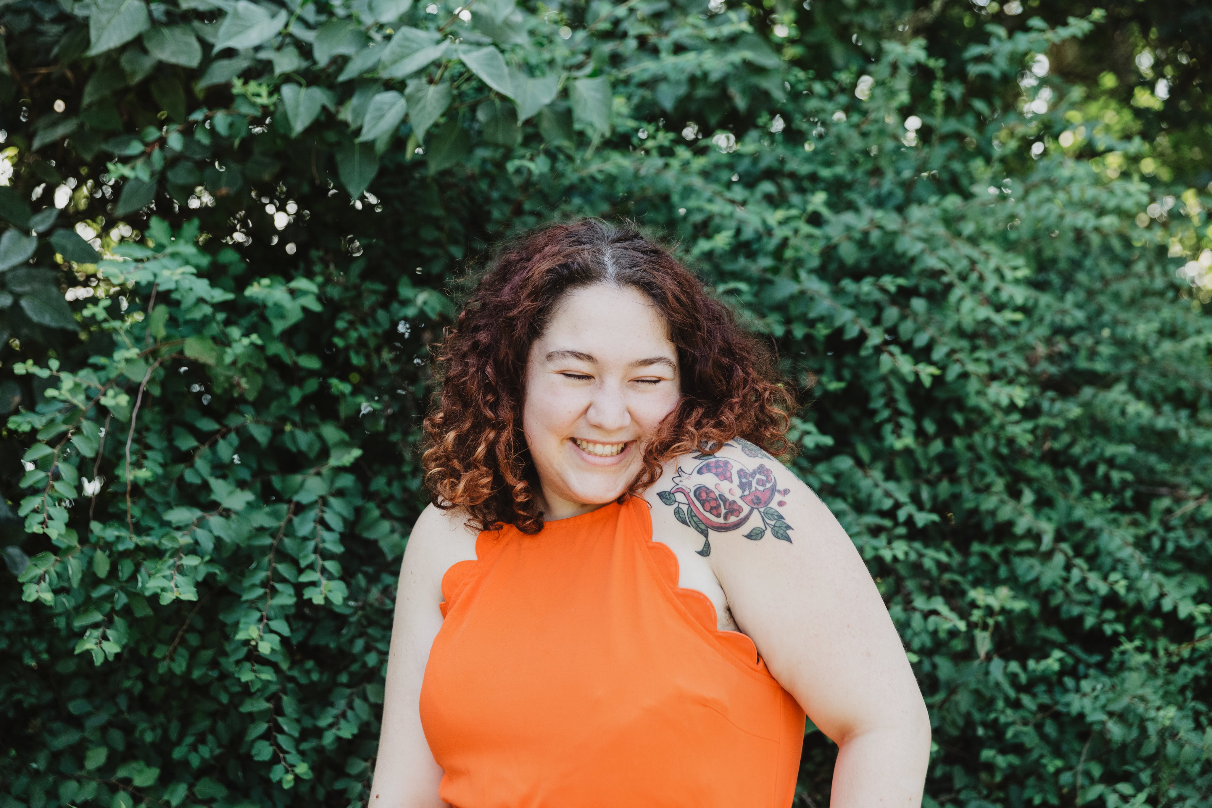 files/young-woman-in-orange-shirt-with-pomegranate-tattoo.jpg